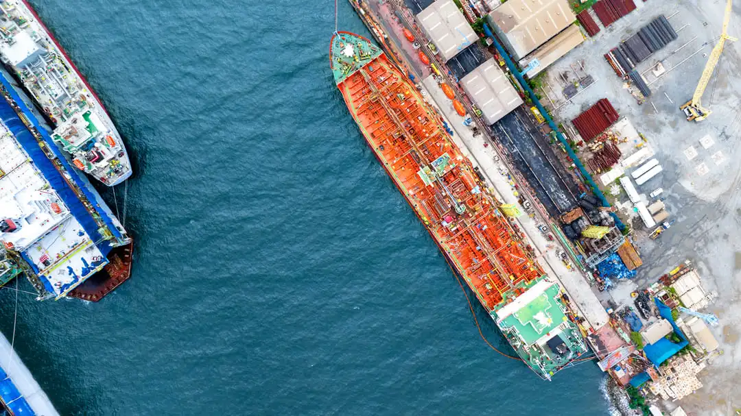 An aerial view of ships docked at a Brazilian port, highlighting maritime logistics and the expertise of a customs broker in Brazil in optimizing international trade.